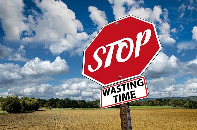Stop sign saying stop wasting time